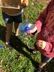 Students working with hand-held fan